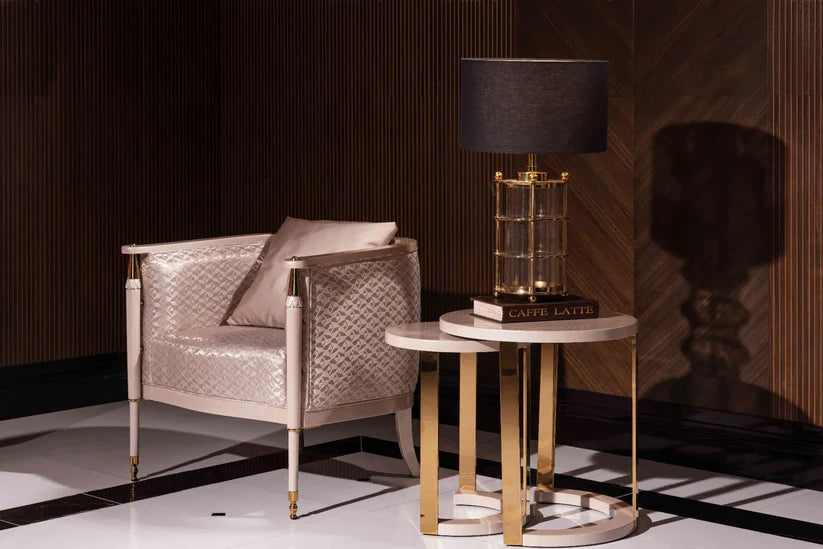 Luxury modern Braga armchair with champagne quilted upholstery and gold-tipped legs in a dark wood lounge