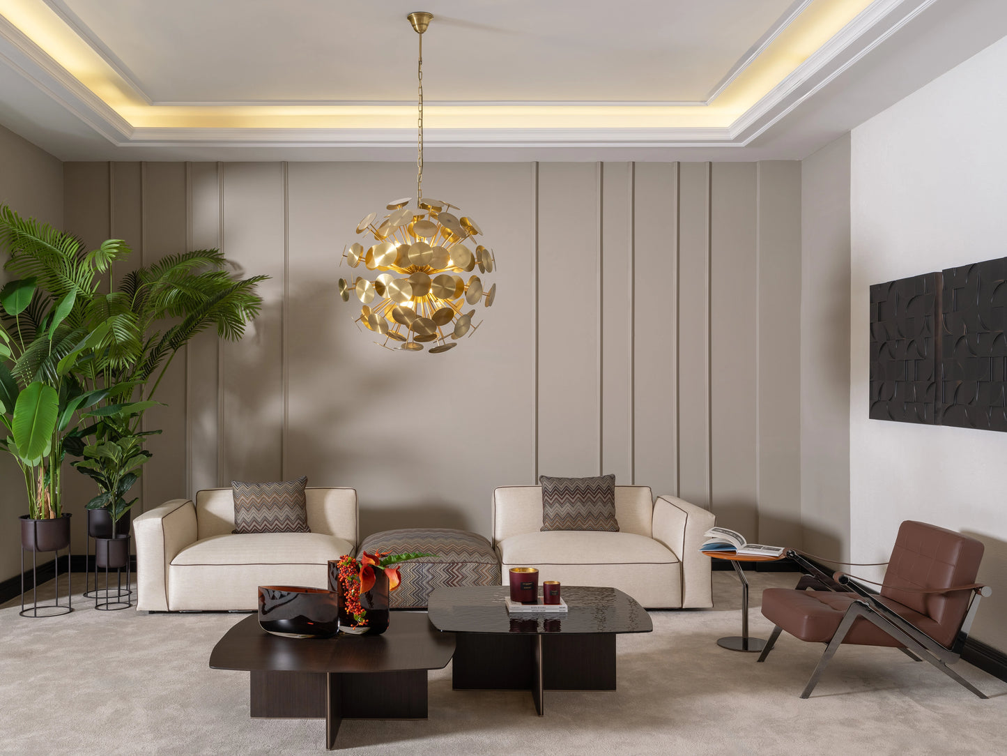 Contemporary living room with two Moka sofas, accent chair, gold pendant light, and plants
