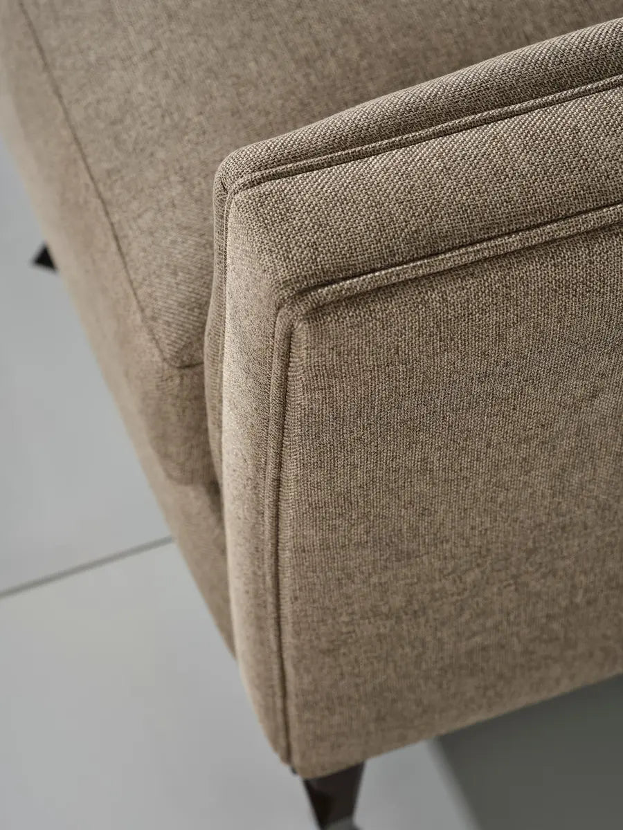 Close-up of Varna 4 seater sofa edge showing fabric and stitch detail.