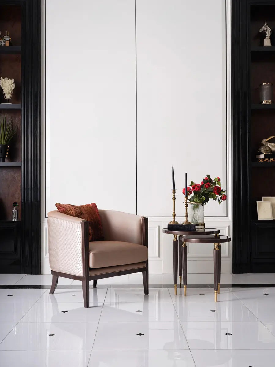 Full view of the armchair with a cushion, part of the Venedik Sofa Set, with a nesting table set of two beside it. Luxe Life Furniture.
