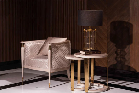 Luxury modern Braga armchair with champagne quilted upholstery and gold-tipped legs in a dark wood lounge