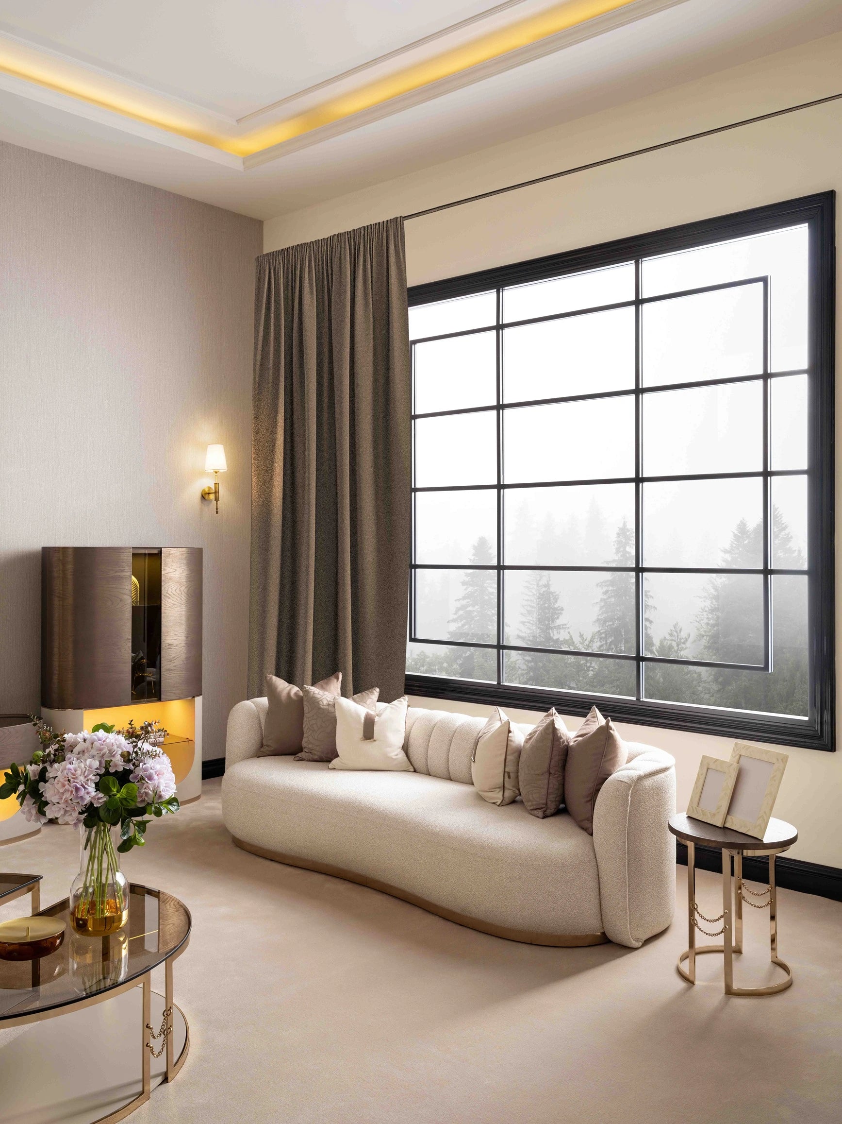Side view of the Calista 4-seater sofa upholstered in a  gray fabric, highlighting the integrated golden metal side table for modern living room furniture.