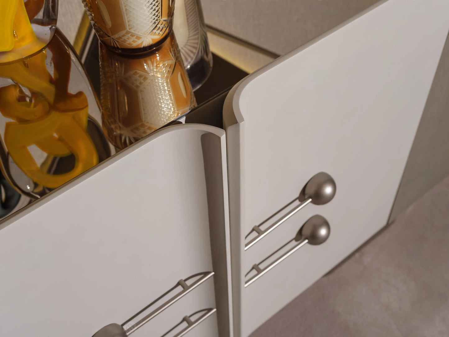 Detail view of Ricamo sideboard with hands opening the elegant storage drawers