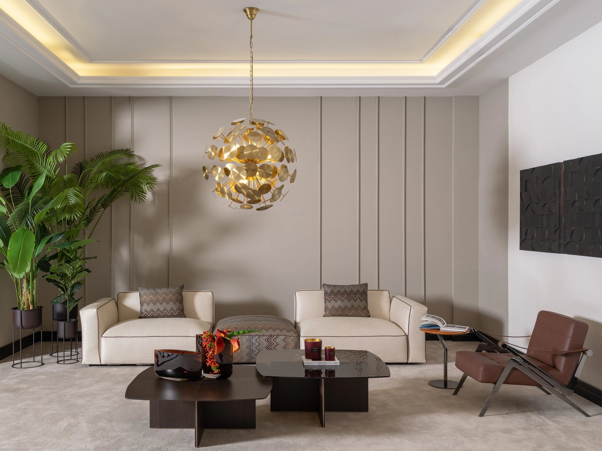 Contemporary living room with two Moka sofas, accent chair, gold pendant light, and plants