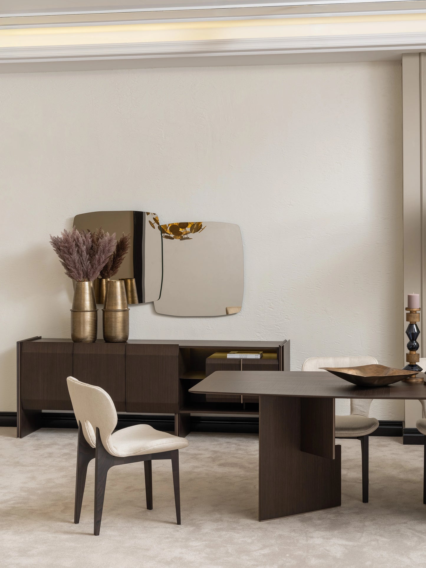 Close-up of Moka dining chair and sideboard with gold vases and decorative mirror