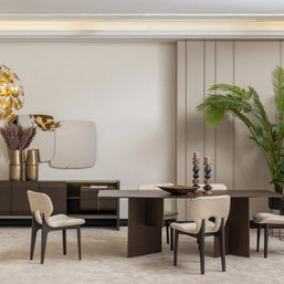 Moka dining set with dark wood table, cream upholstered chairs, sideboard, gold vases, and statement mirror