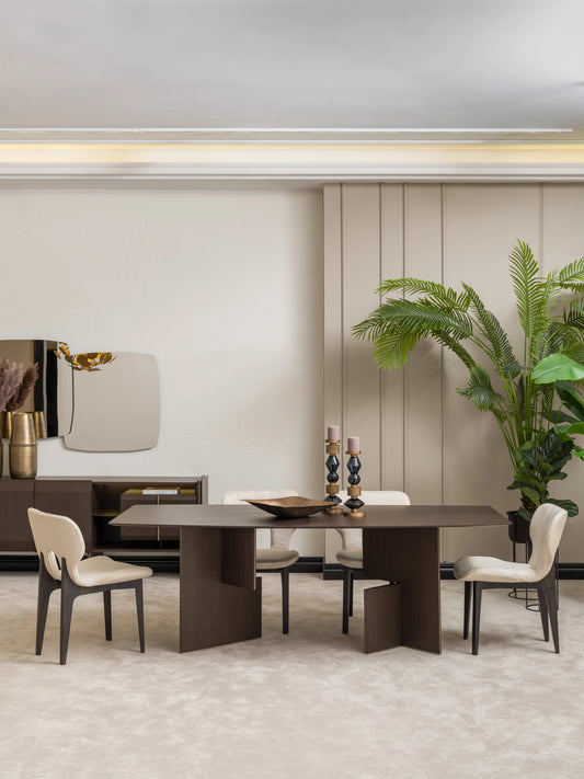 Moka dining room set with six cream upholstered chairs, dark wood table, gold chandelier, and large plants