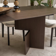 Detailed view of Moka dining table leg design and cream upholstered chair