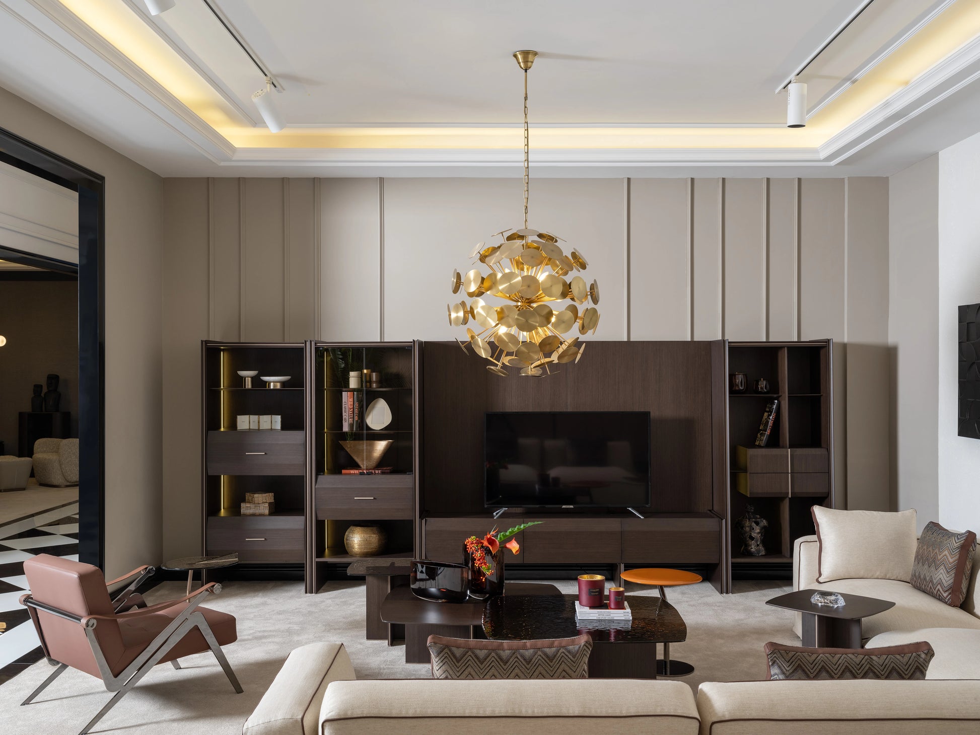 Modern living room with Moka TV unit, gold pendant light, accent chairs, and coordinated shelving
