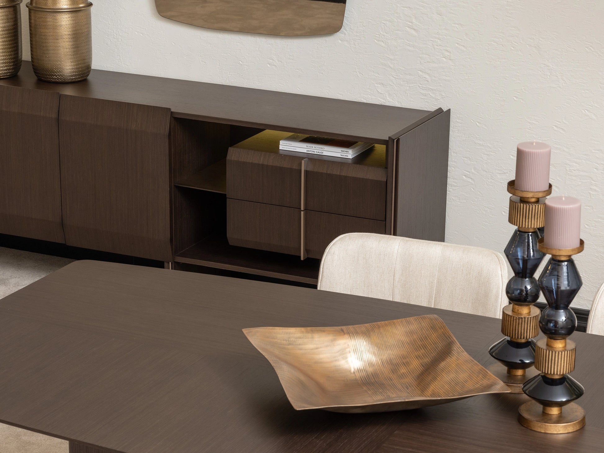 Close-up of Moka sideboard and gold decor beside contemporary dining table