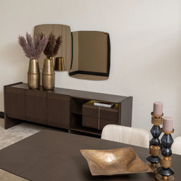 Moka sideboard with gold vases and modern mirror behind dark wood dining table