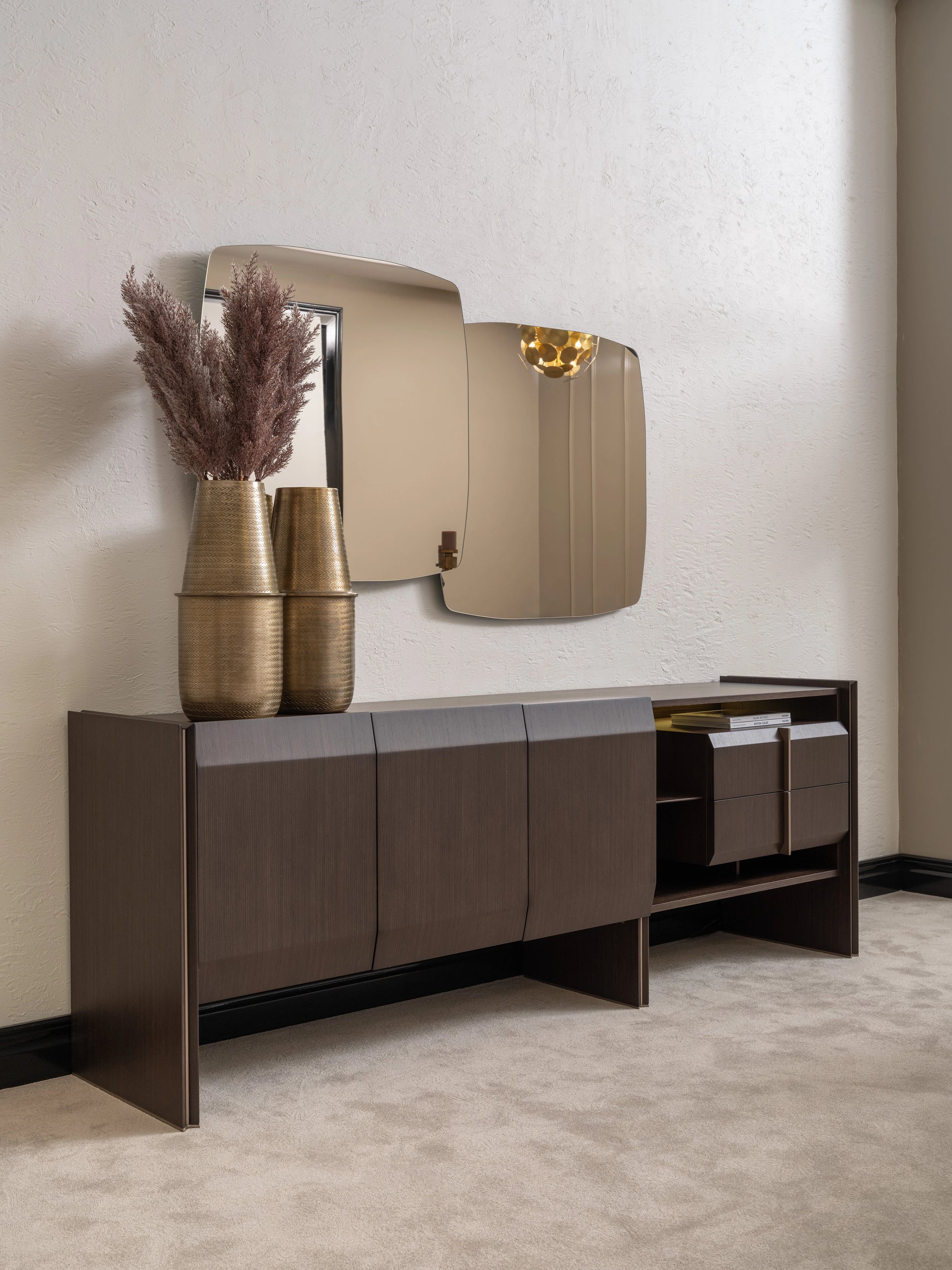 Contemporary Moka sideboard with gold vases and statement mirror on neutral wall