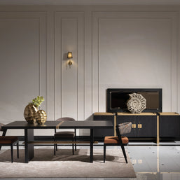 Elegant dining area featuring a black dining table with a decorative centerpiece, surrounded by matching chairs. The room is adorned with sophisticated wall sconces, a decorative sideboard, and a large mirror, creating a luxurious and spacious ambiance.